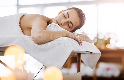 Buy stock photo Calm, massage and relax with woman in spa, on bed or table for luxury treatment or wellness. Peace, quiet and stress relief with customer in health resort for alternative therapy or holistic healing