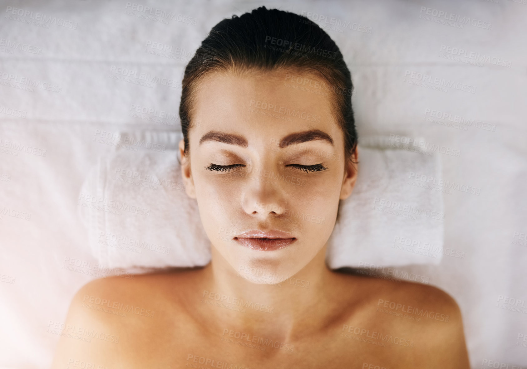 Buy stock photo Closeup shot of a young woman relaxing on a spa bed