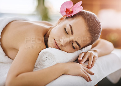 Buy stock photo Face, flower and massage with woman in spa, on bed or table for luxury treatment or wellness. Peace, relax and stress relief with customer in health resort for alternative therapy or holistic healing