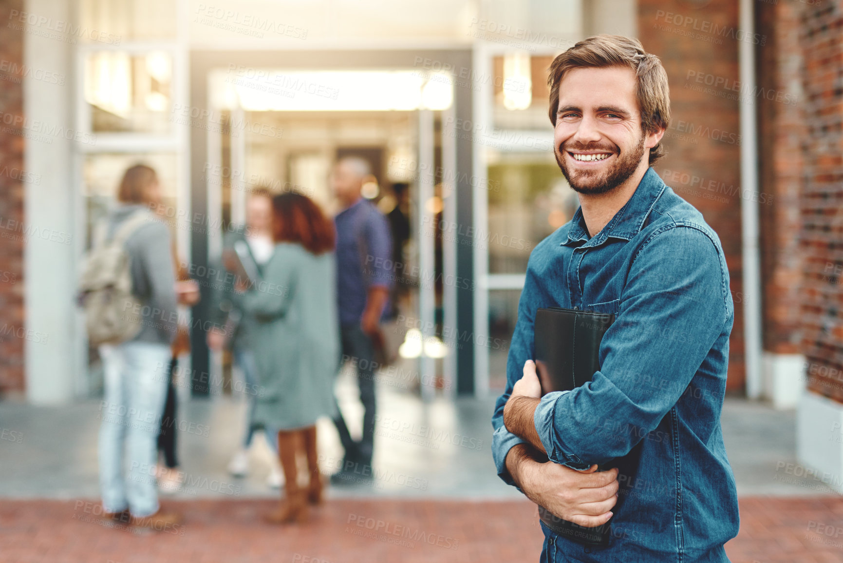 Buy stock photo Man, portrait and smile at university for education, building for learning at academy. Male student, college campus and excited for scholarship opportunity, happiness and pride or knowledge notebook