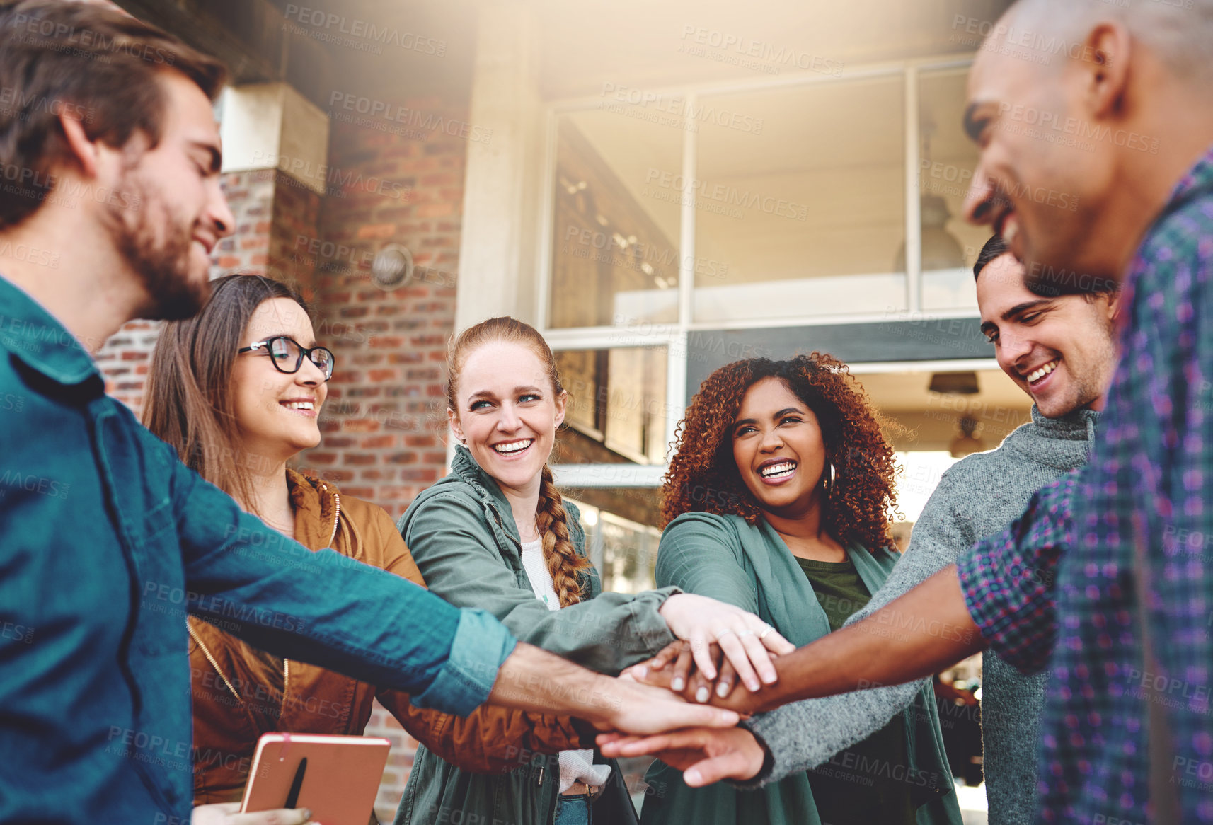 Buy stock photo Excited, teamwork and students with hands in stack for support at university, agreement and studying goal. Diversity, smile and happy people with group, community and learning for education growth