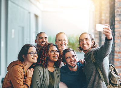 Buy stock photo Portrait of a group of happy young students taking a selfie together on campus