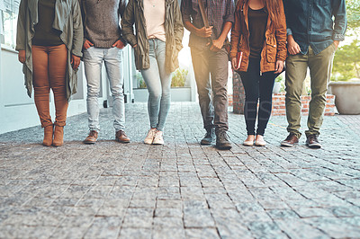 Buy stock photo Cropped shot of a group of young students standing together outdoors on campus