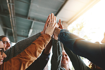 Buy stock photo Shot of a group of young students joining their hands together in solidarity on campus