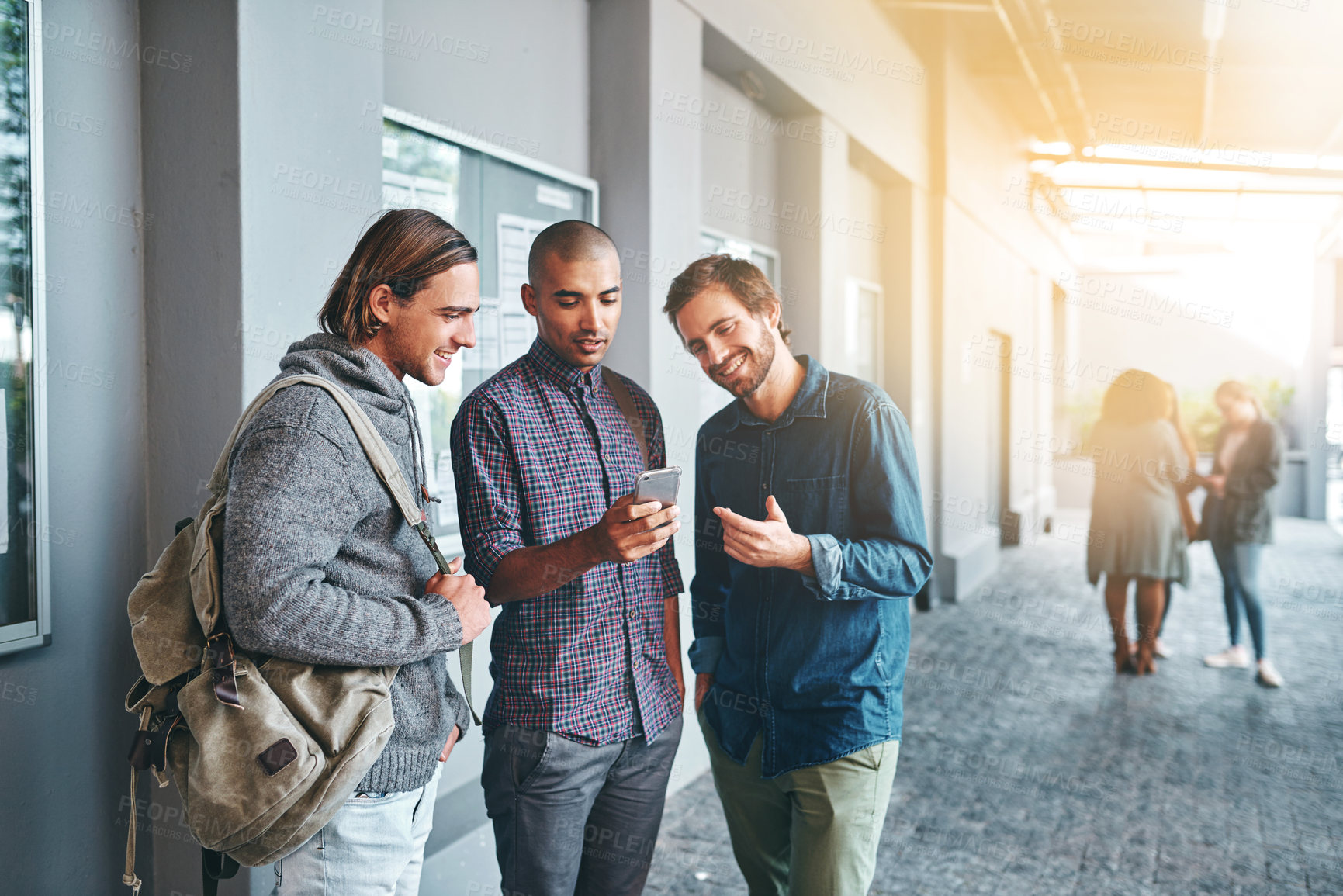 Buy stock photo Smile, students and friends with conversation or smartphone for networking, social media and academy website. Male people, online and communication on university campus with diversity and scholarship