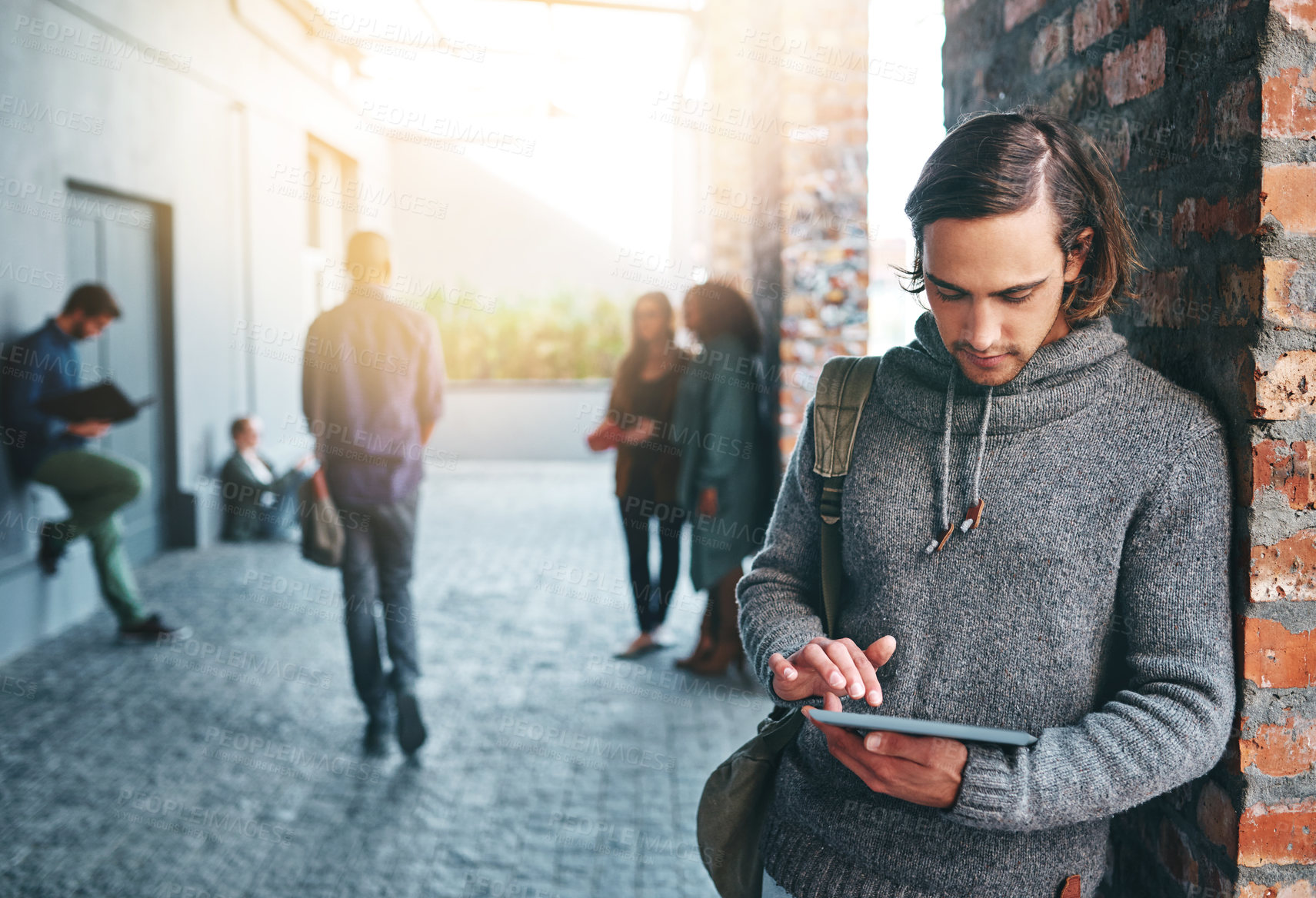 Buy stock photo University student, man and scroll tablet on campus for education research, academic learning or online study. Gen z, person or digital tech outdoor on college website for test results or scholarship