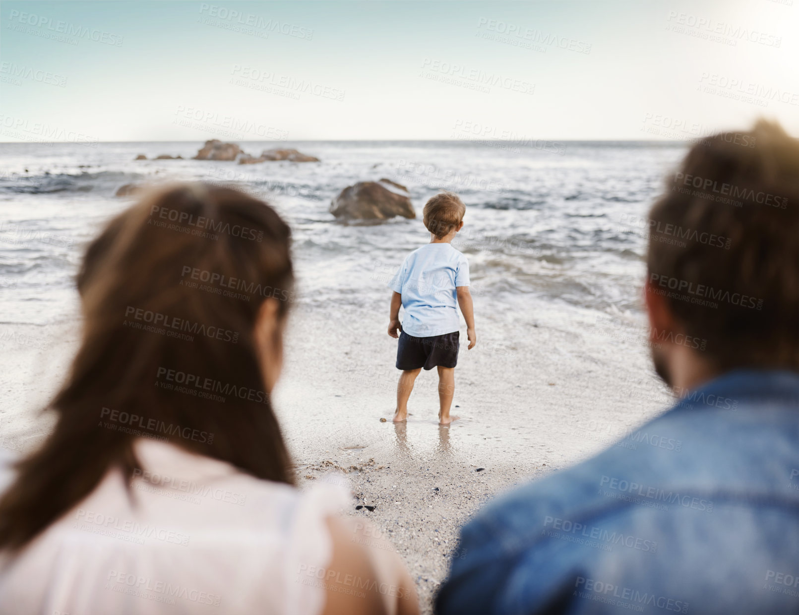 Buy stock photo Back, family and child on beach outdoor for summer vacation, bonding and support with love of travel location. Parents, boy and ocean waves with sensory development, explore game and nature play