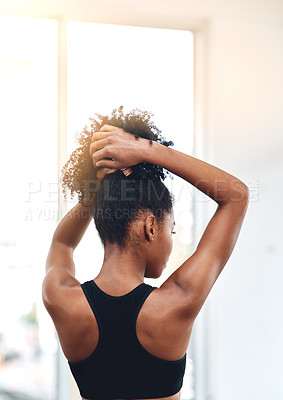 Buy stock photo Rearview shot of a young woman holding up her hair
