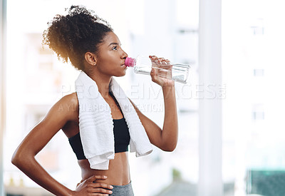 Buy stock photo Fitness, young woman athlete and water or bottle for exercise hydration or after workout with towel and in gym. Bodybuilding, training and wellness or girl runner drink or detox sweat and healthy