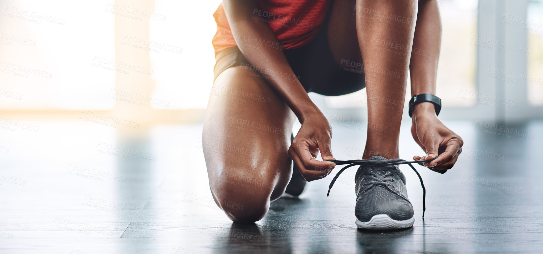 Buy stock photo Shoes, fitness and woman tying laces to start exercise, workout or wellness sport in a gym for health performance. Sneakers, banner and hands of a healthy person or runner ready for training