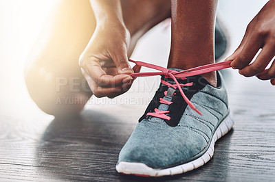Buy stock photo Shoes, closeup and person tying laces to start exercise, workout or wellness sport in a gym for health performance. Sneakers, sports and hands of a healthy woman or runner ready for training