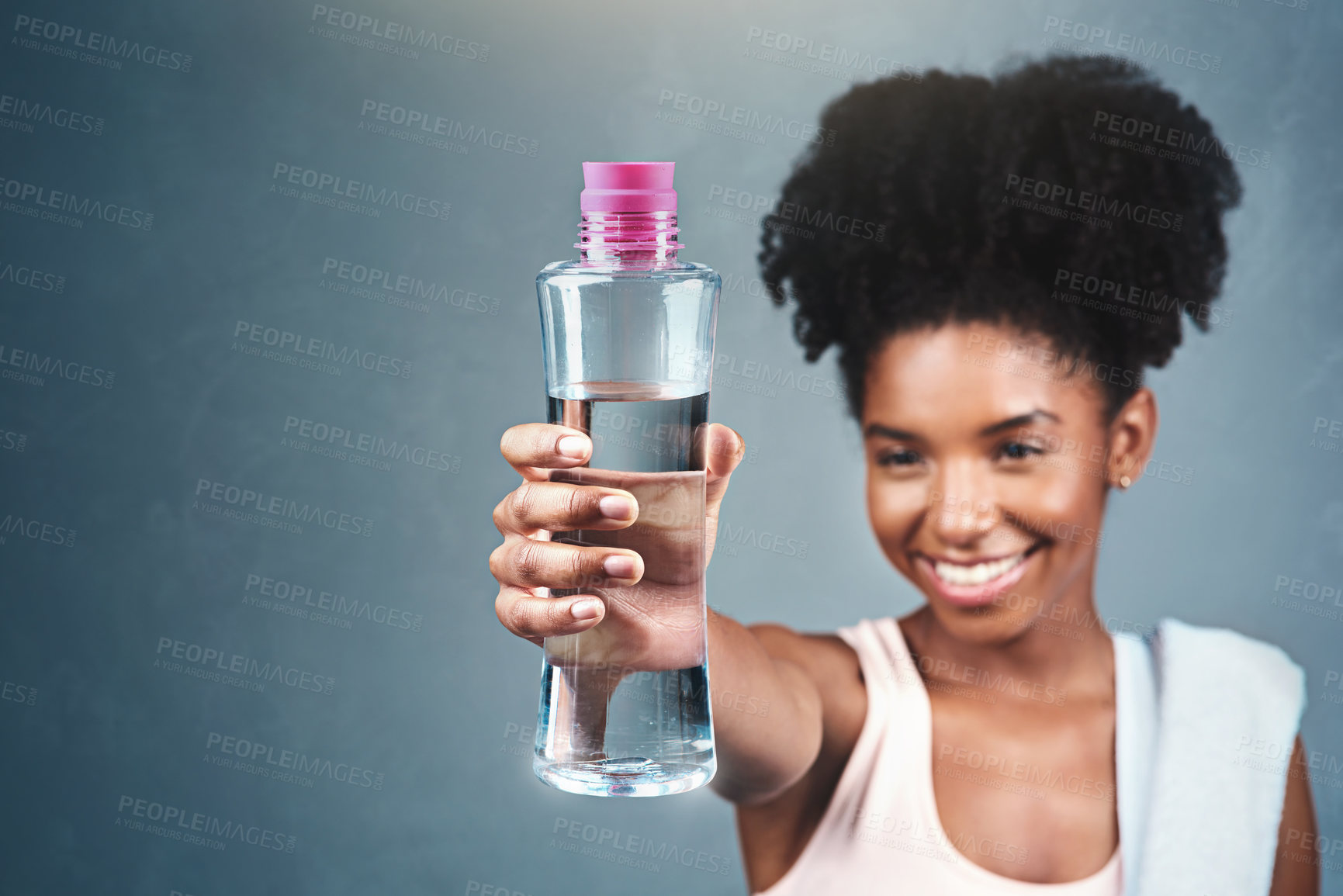 Buy stock photo Fitness, bottle and happy woman with water offer in studio for training, workout or hydration satisfaction on grey background. Sports, liquid or athlete smile for hydrogen, drink or exercise recovery