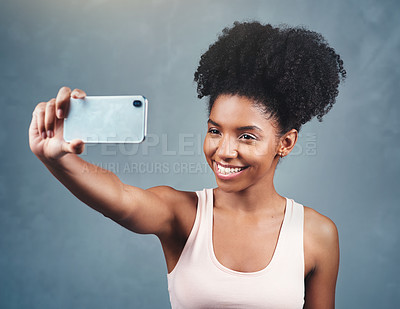 Buy stock photo Fitness, selfie and happy woman in studio for streaming, photography and profile picture on grey background. Smartphone, smile and social media health influencer with exercise blog content creation