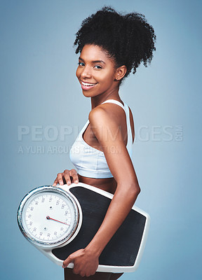 Buy stock photo Black girl, portrait and scale in studio to weigh, confident measure and blue background. Female person, fitness and diet for balance, exercise results and proud of weight loss success and health