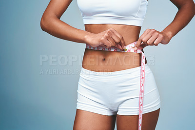 Buy stock photo Girl, hands and tape on stomach in studio to measure weight loss or progress of diet and daily exercise. Woman, grey background and measurement for improvement of new prescription drug or tummy tuck.