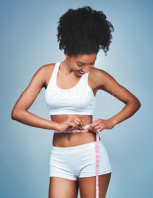 Buy stock photo Girl, happy and tape on stomach in studio to measure weight loss, progress of diet and daily exercise. Woman, grey background and measurement for improvement of new prescription drug or tummy tuck.