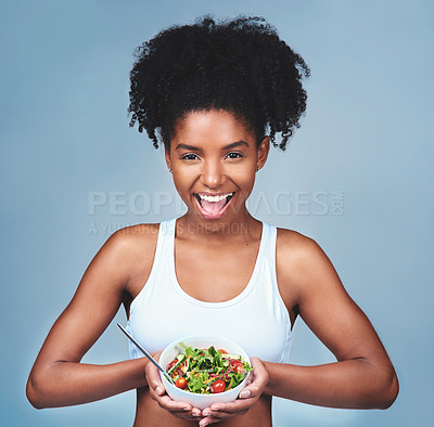 Buy stock photo Fitness, portrait and happy woman with salad in studio for breakfast, balance or gut health wellness or diet on blue background. Green bowl, brunch and vegan meal for superfoods, detox or cleanse