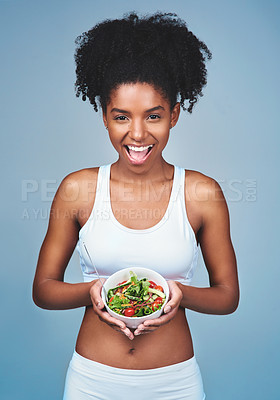 Buy stock photo Studio shot of an attractive young woman eating salad against a grey background
