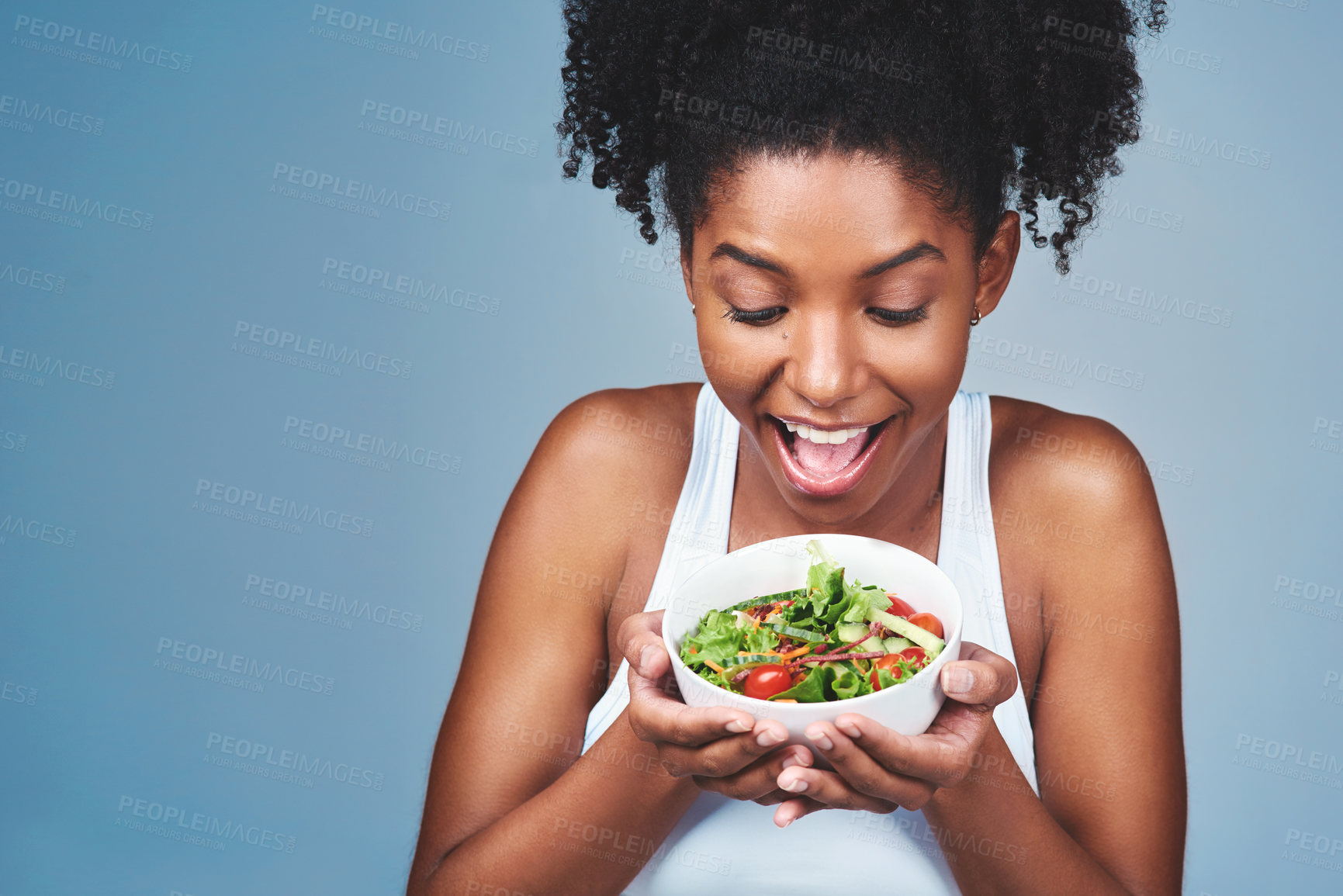 Buy stock photo Healthy food,  happy and black woman with salad, studio and balance of diet, nutrition and wellness. Blue background, vegan and hungry for eating, detox and benefits for digestion, body and model