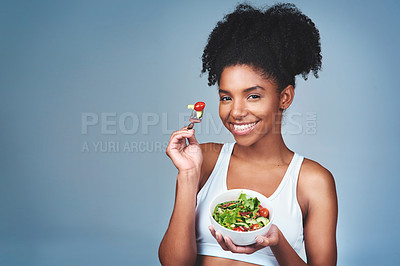 Buy stock photo Space, portrait or black woman with salad in studio for healthy meal, nutrition diet or digestion benefits. Mockup, vegetables and happy female fitness model eating food isolated on blue background