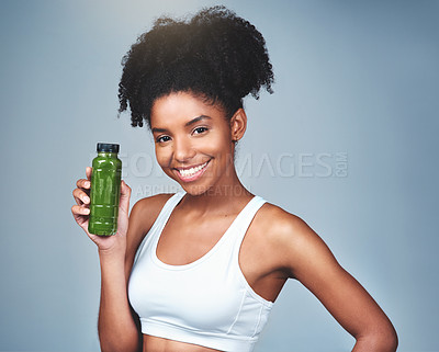 Buy stock photo Green, juice and healthy for black woman, studio and container for smoothie, vegan and detox for diet. Blue background, nutrition and breakfast for girl, benefits and vitamin c from vegetables