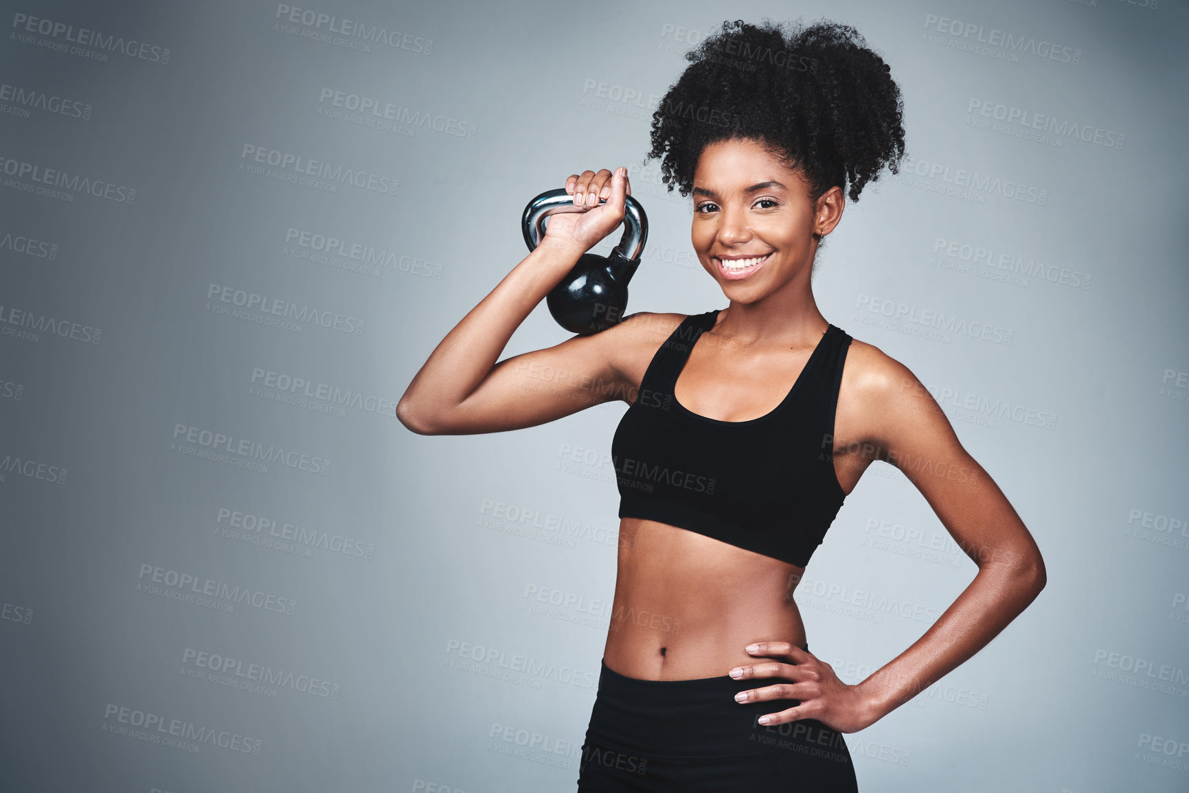 Buy stock photo Happy, black woman and workout with kettle bell in studio on grey background to exercise for health or fitness. Female person, portrait and confident for gym or training, wellbeing and wellness