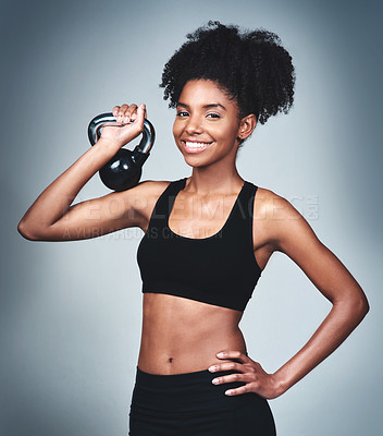 Buy stock photo Smile, black woman and workout with kettle bell in studio on grey background to exercise for health or fitness. Female person, portrait and weights for gym or training, wellbeing and wellness