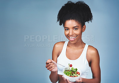Buy stock photo Space, portrait or happy black woman with salad in studio for healthy meal, nutrition diet or digestion benefits. Smile, vegetables and female fitness model eating food isolated on blue background