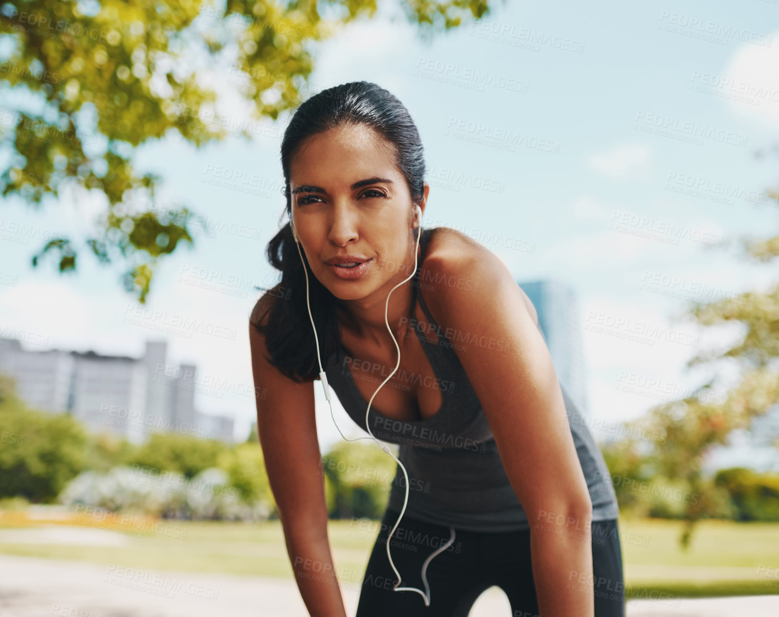 Buy stock photo Fitness, rest and woman in park with music for exercise, marathon training and running for wellness. Sports, breathe and person with earphones listening to workout playlist, audio and radio on break