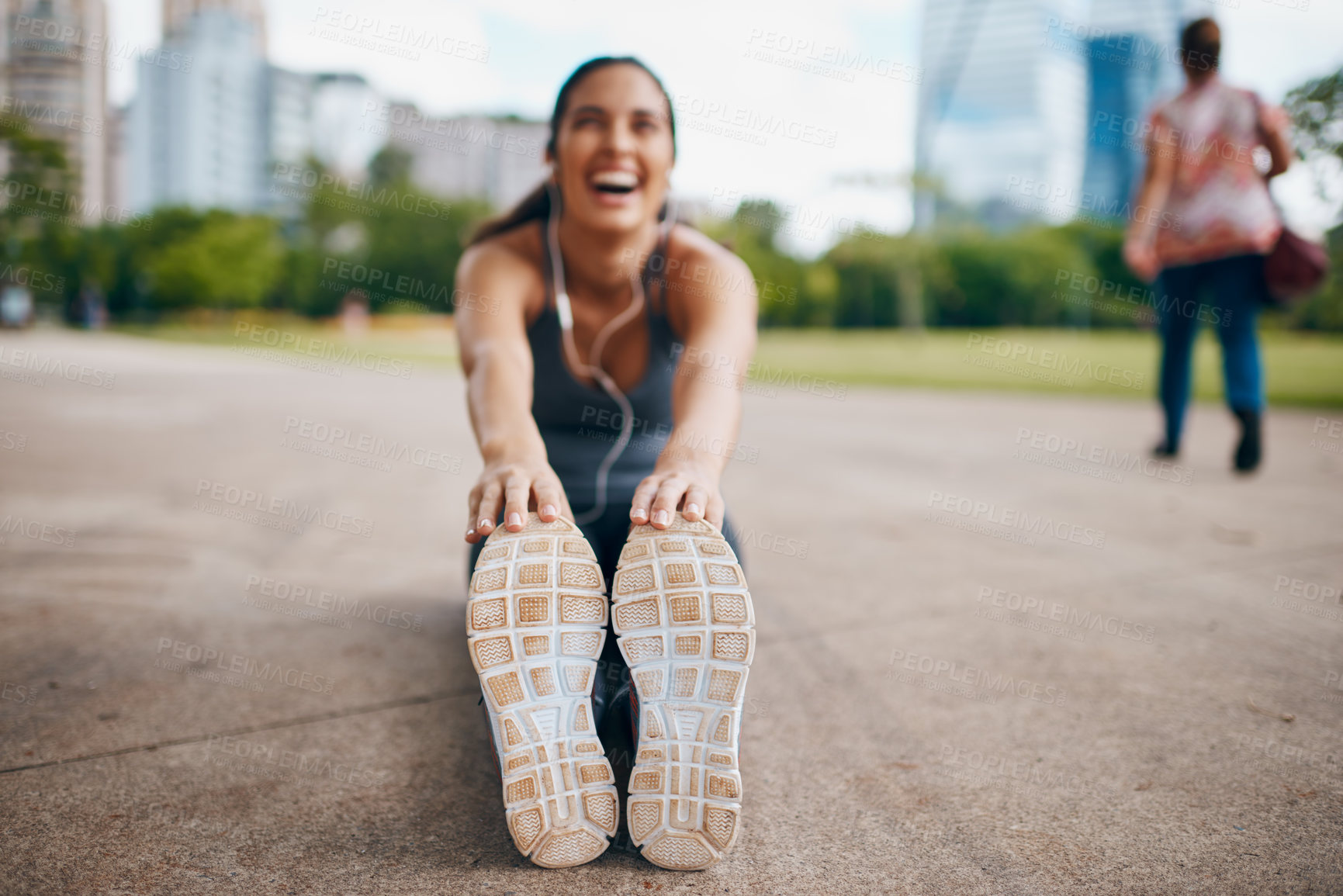 Buy stock photo Woman, fitness and stretching legs with shoes outdoor for healthy body, flexible and exercise. Sports, hands and runner warm up muscle, laugh or listening to music to prepare for workout on city road