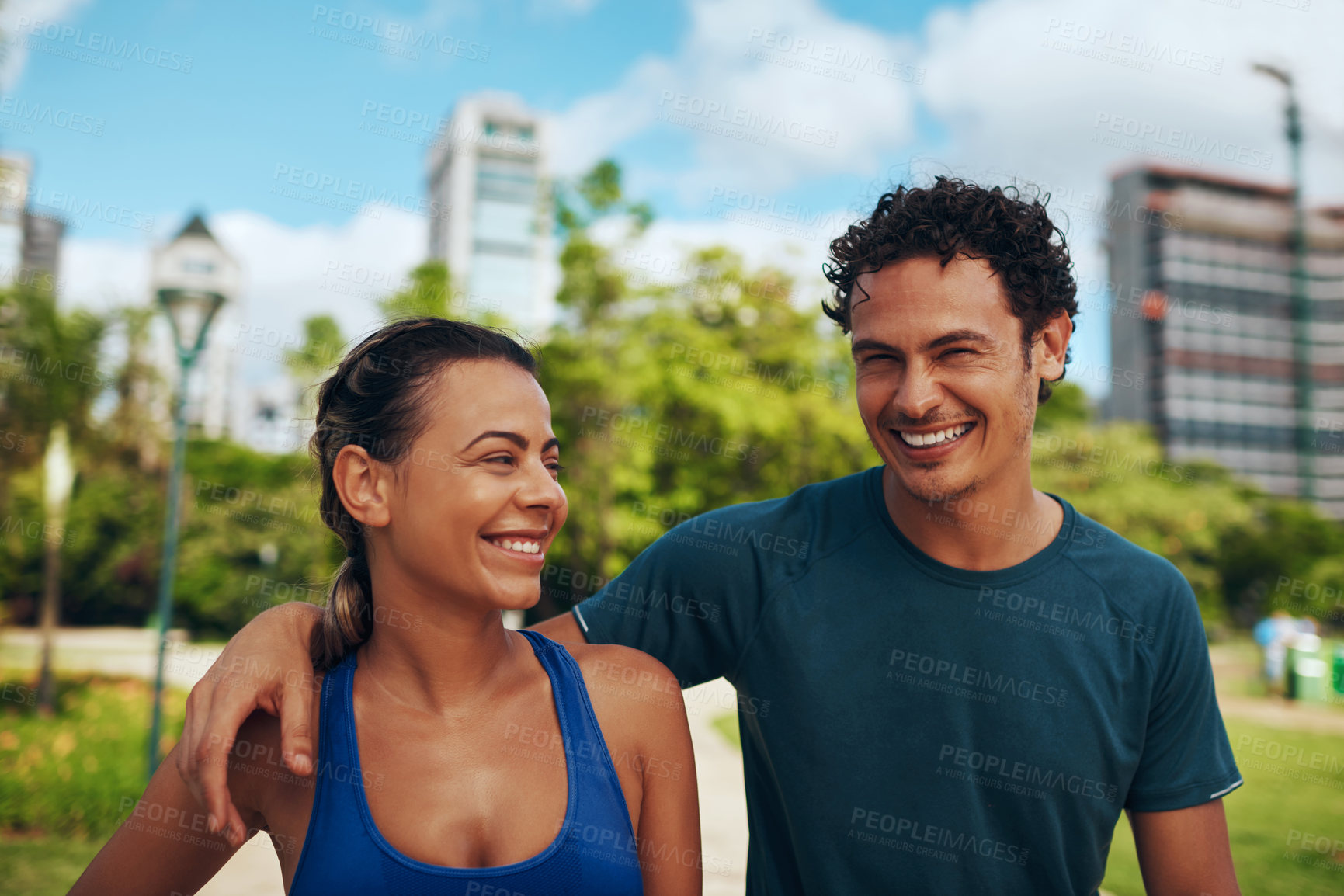 Buy stock photo Cropped shot of an affectionate young sporty couple working out together outdoors