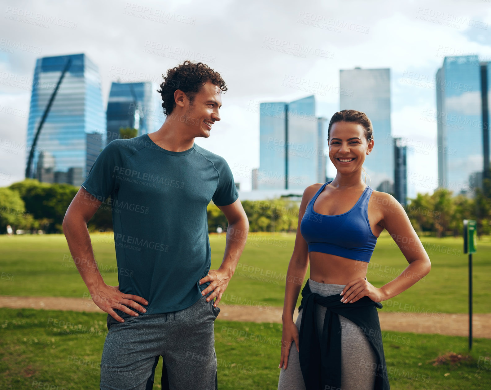 Buy stock photo Cropped shot of an affectionate young sporty couple working out together outdoors