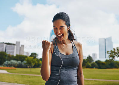 Buy stock photo Cropped shot of an attractive young sportswoman cheering while working outdoors in the city