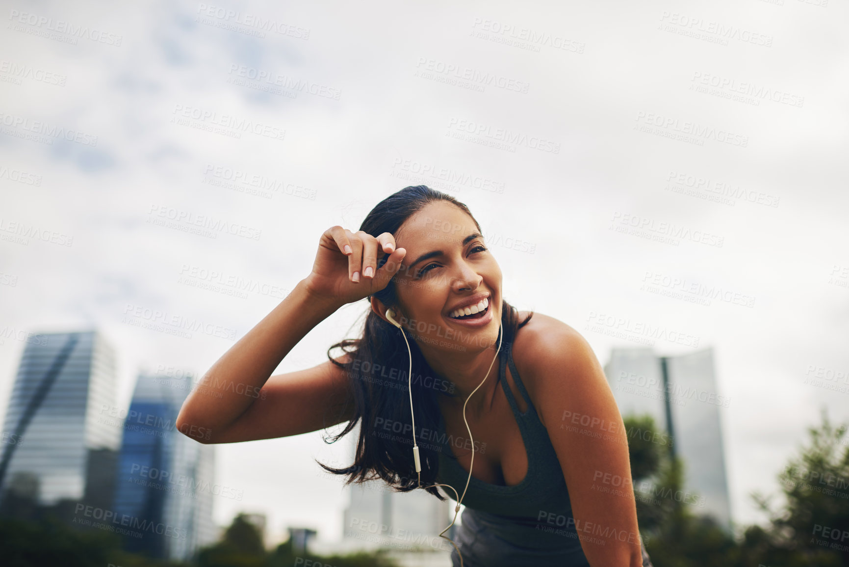 Buy stock photo Cropped shot of an attractive young sportswoman taking a break from working out outdoors