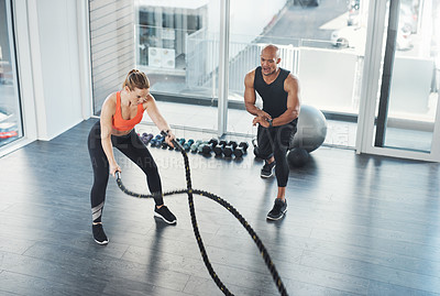 Buy stock photo Wellness, trainer and rope exercise in gym, motivation and people in fitness centre for training and strong muscles. Coaching, health and support for full body workout, challenge with athletes