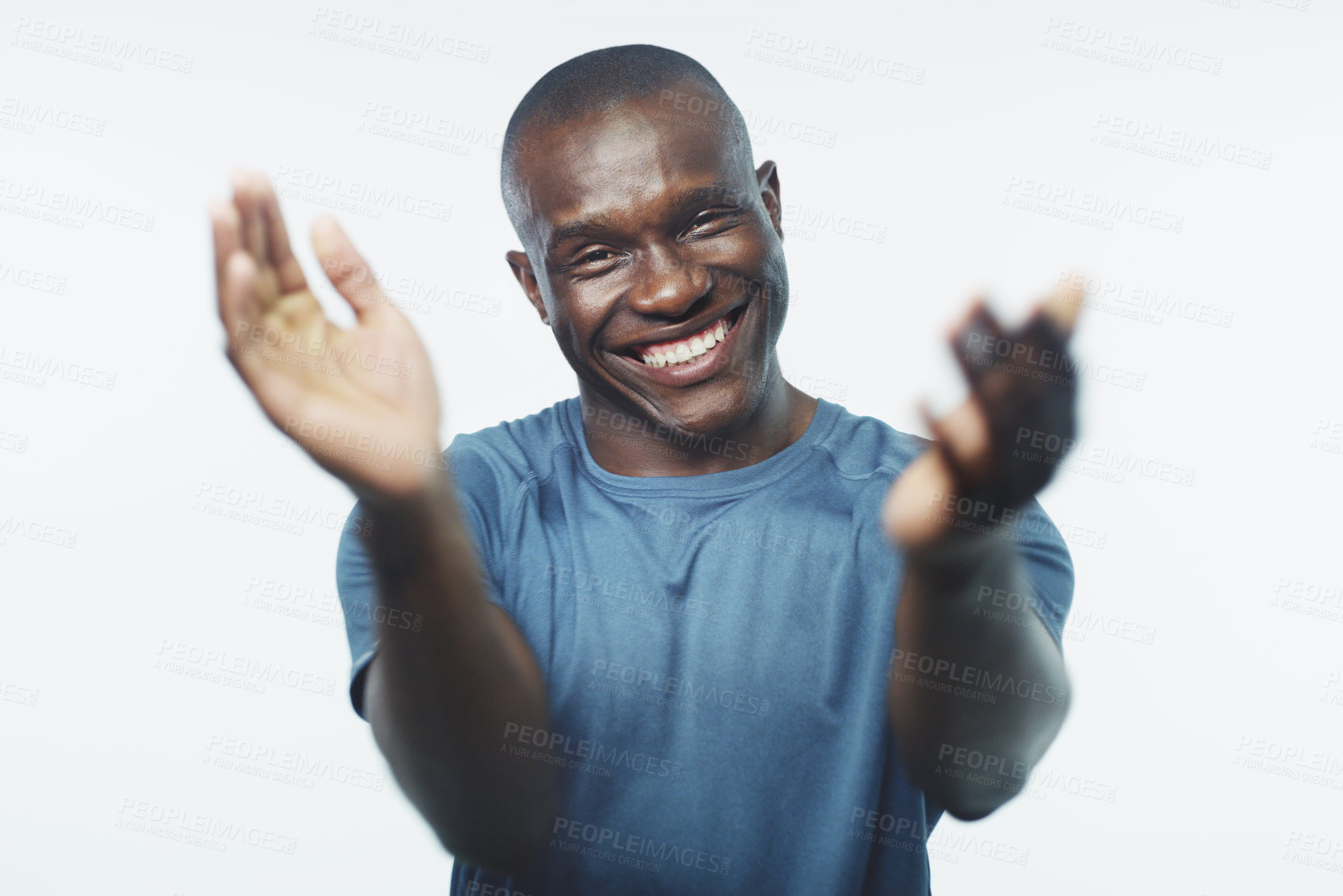 Buy stock photo Studio shot of a handsome young man clapping his hands against a grey background