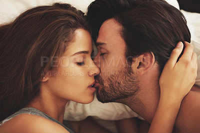 Buy stock photo Top view, couple and kiss in bedroom for relax, love and bonding together for care in home. Morning, romantic man and intimate woman in bed for healthy relationship, connection and passion in house