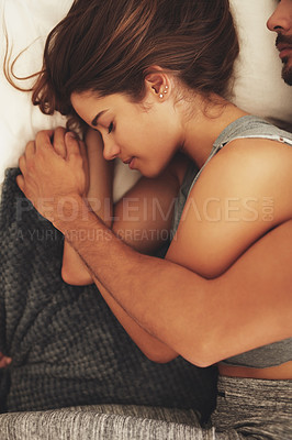 Buy stock photo Shot of a young couple sleeping peacefully together at home
