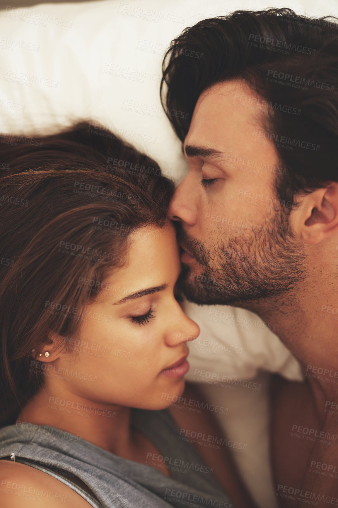 Buy stock photo Above, couple and love with forehead kiss, intimacy and affection in home for bonding, relax and sleep on weekend. Woman, man and connection for marriage, commitment and partner with happy in bedroom