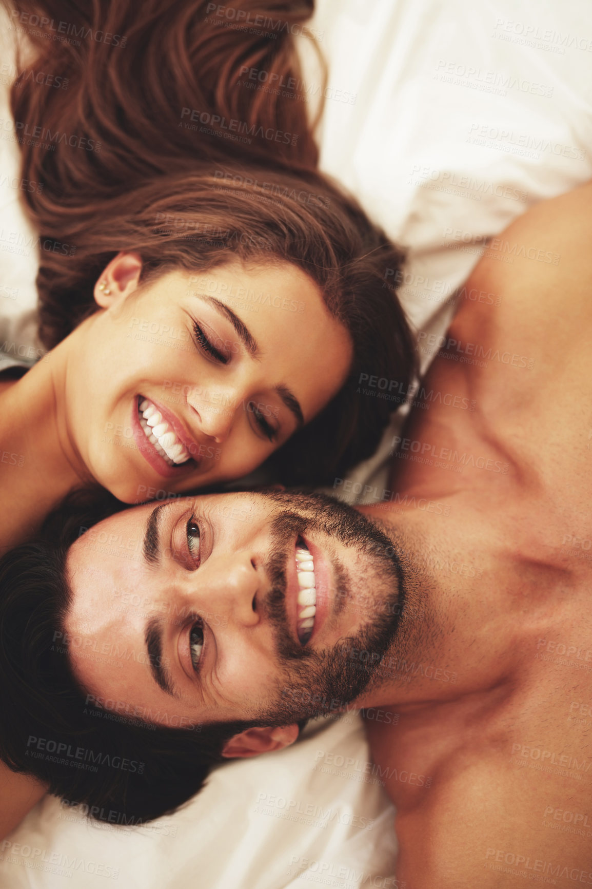 Buy stock photo Smile, love and couple on bed in home for relaxing morning on weekend together from above. Happy, joy and high angle of young man and woman resting in bedroom for bonding and connection at house