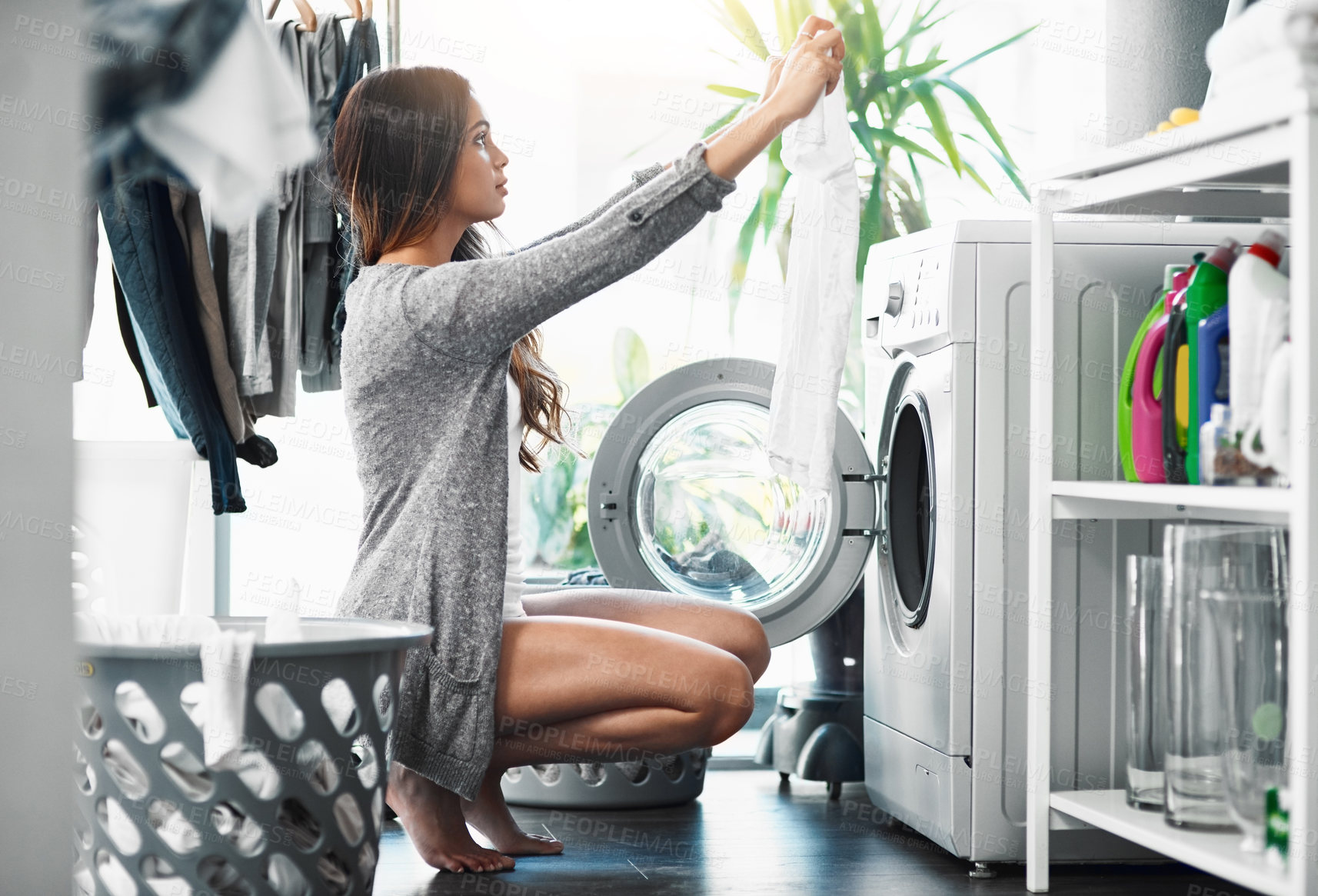 Buy stock photo Woman, check laundry and washing machine for cleaning in home, hygiene and loading clothing in appliance. Female person, shirt and housework tasks on morning, sorting and routine of dryer on floor