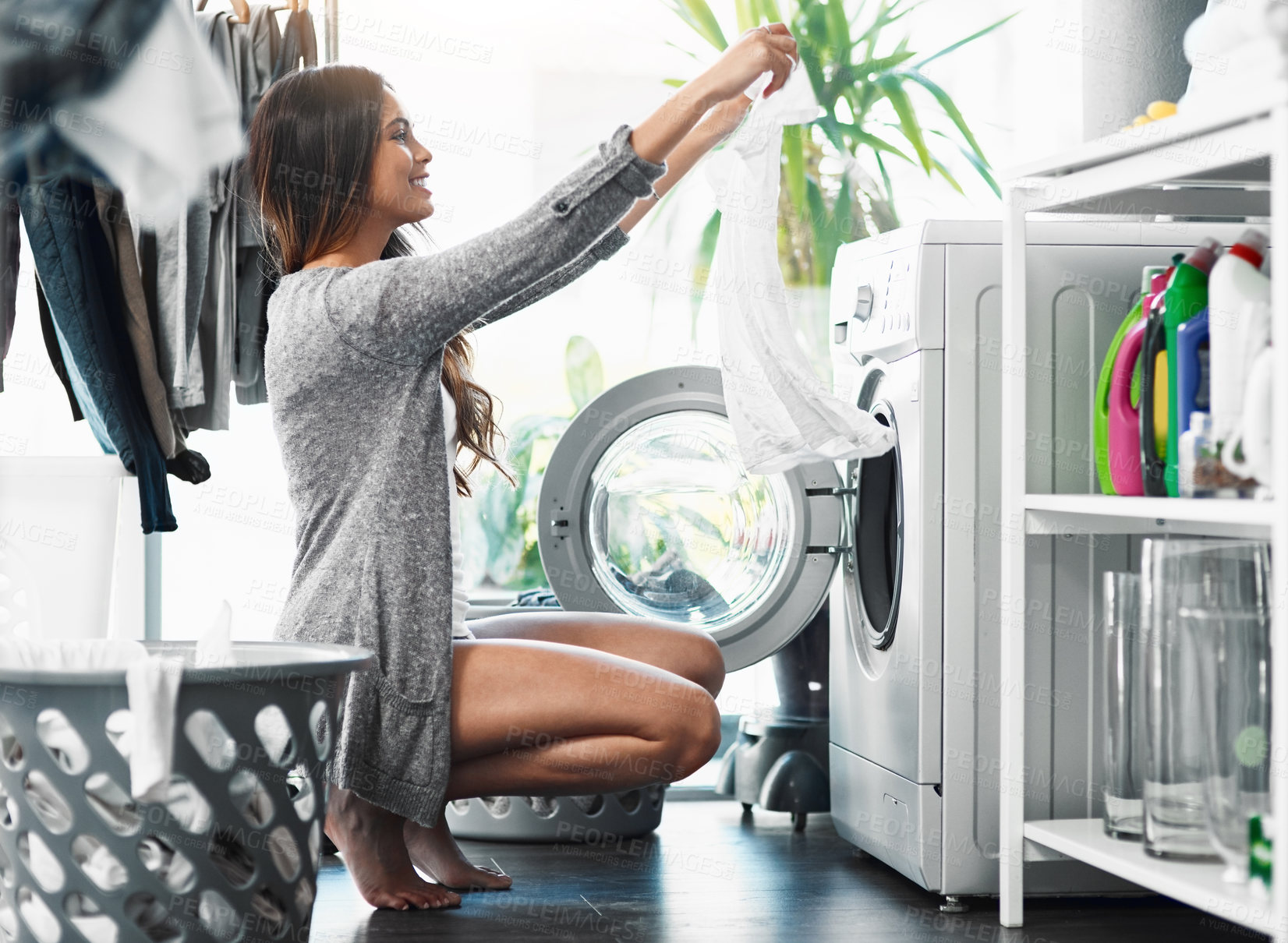 Buy stock photo Woman, check clothes and washing machine for cleaning in home, hygiene and loading laundry in appliance. Female person, shirt and housework tasks on morning, cotton and routine of dryer on floor