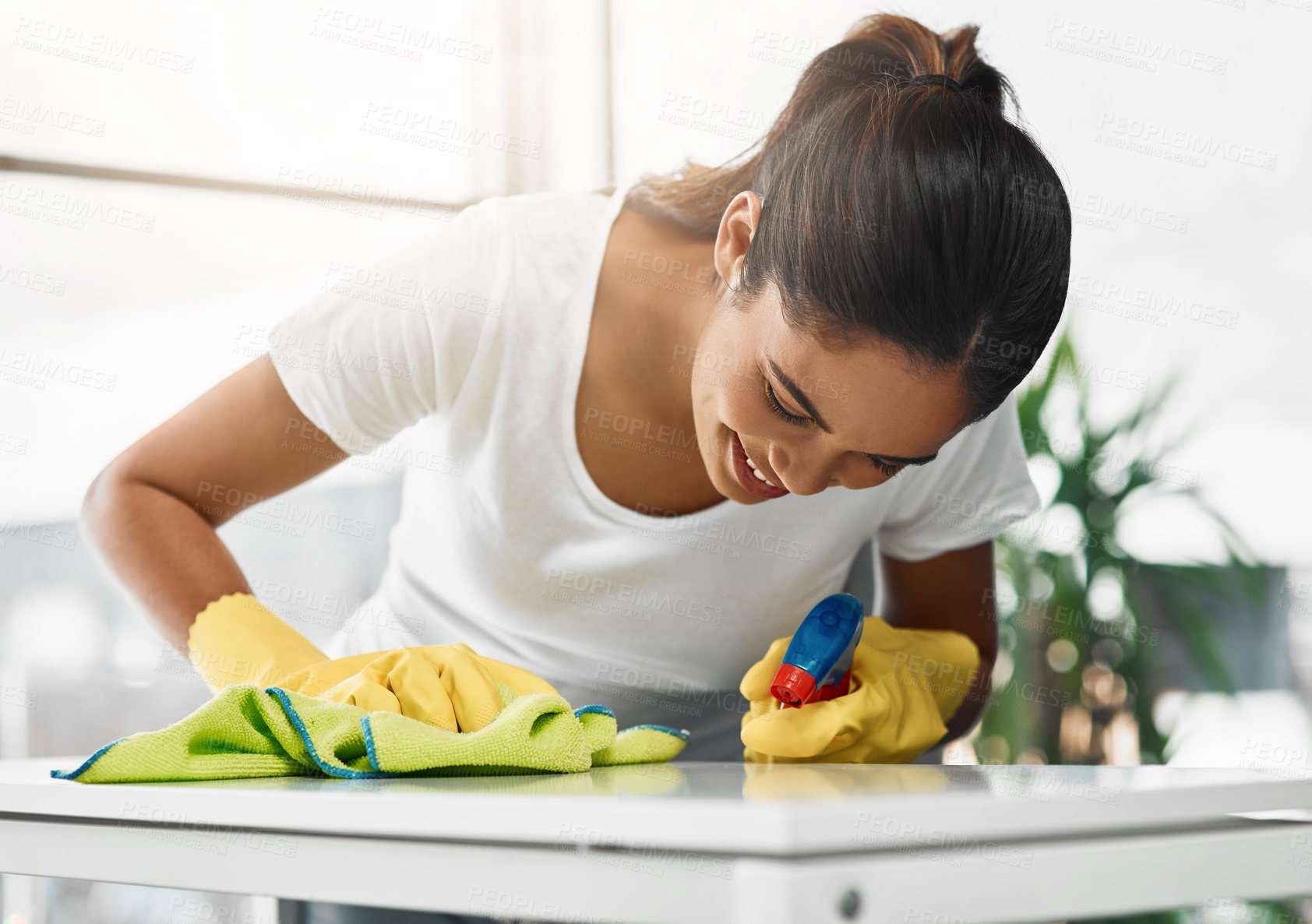 Buy stock photo Woman, cleaning and spray detergent on kitchen counter for disinfect, hygiene and safety from germs risk. Female cleaner, washing surface and chemical for virus, dust and gloves of maintenance shine