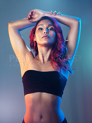 Buy stock photo Studio portrait of a beautiful young woman posing against a multi colored background
