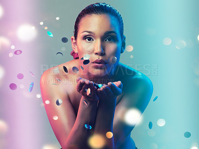 Buy stock photo Studio portrait of a beautiful young woman blowing a kiss while standing against a multi colored background