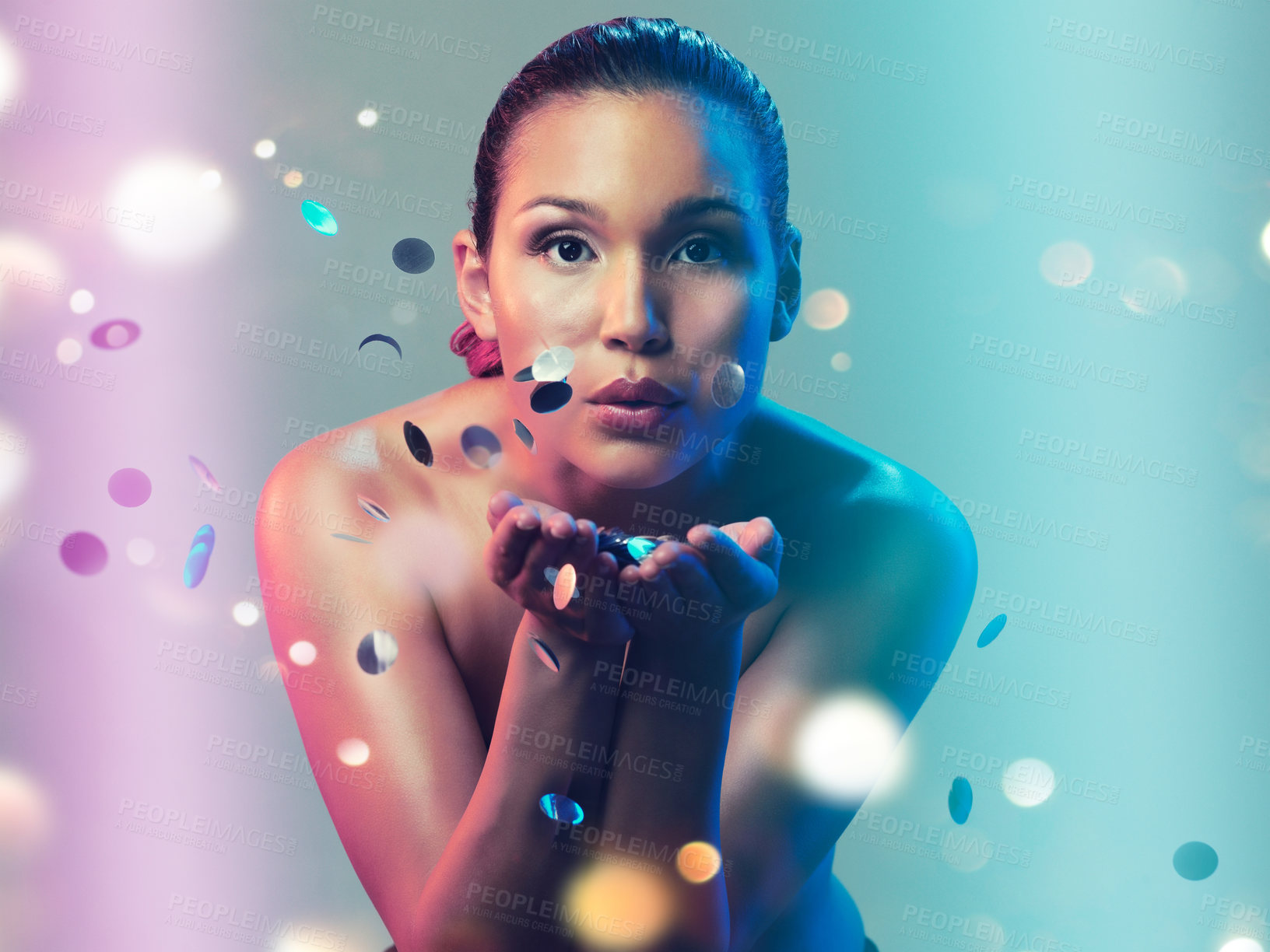 Buy stock photo Studio portrait of a beautiful young woman blowing a kiss while standing against a multi colored background