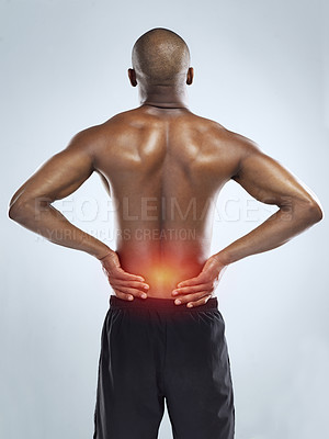 Buy stock photo Rearview shot of an athletic young man with cgi highlighting his injury against a grey background