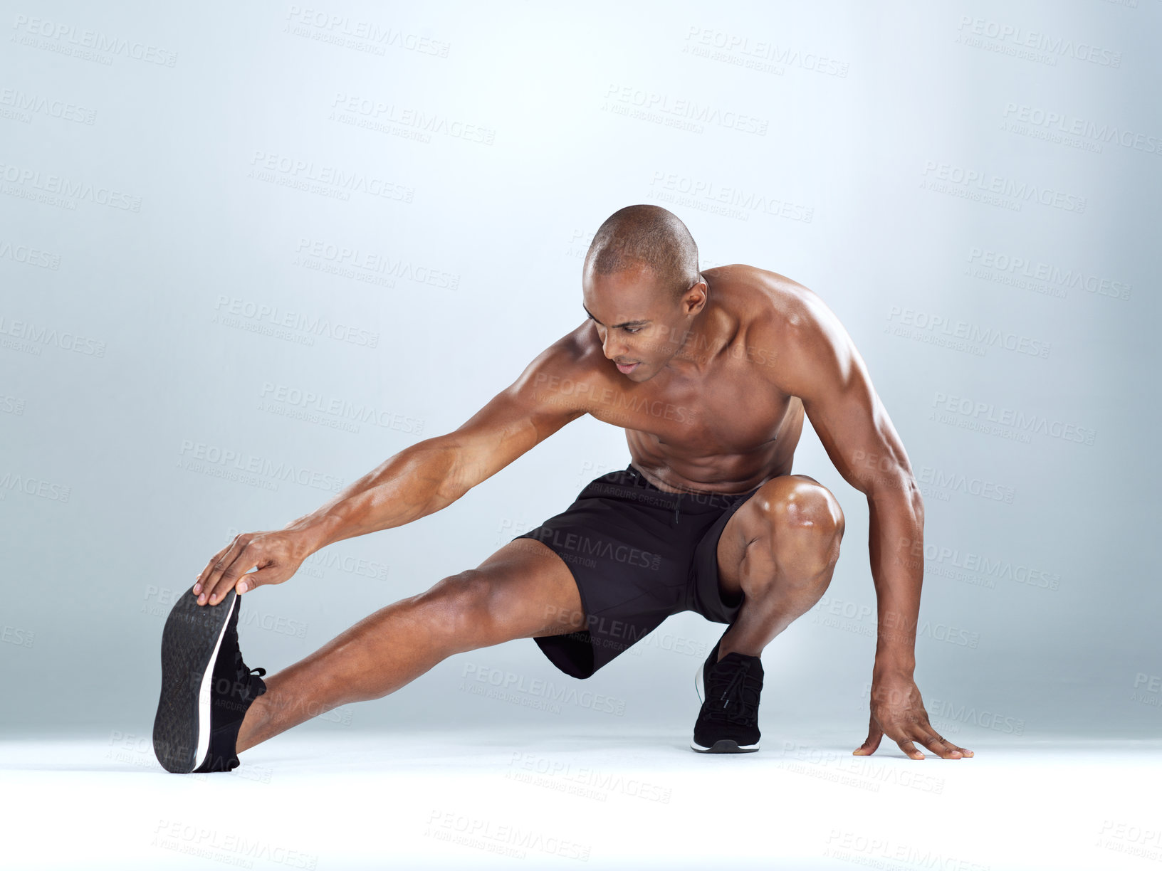 Buy stock photo Man, legs and stretching for training in studio for balance, exercise and calf muscle by white background. African person, bodybuilder and warm up on floor for fitness, workout and transformation