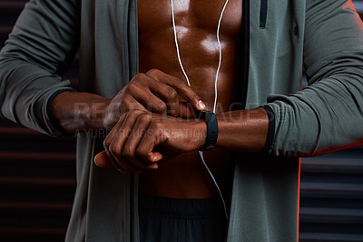 Buy stock photo Studio shot of an unrecognizable male athlete looking at his wrist watch against a grey background
