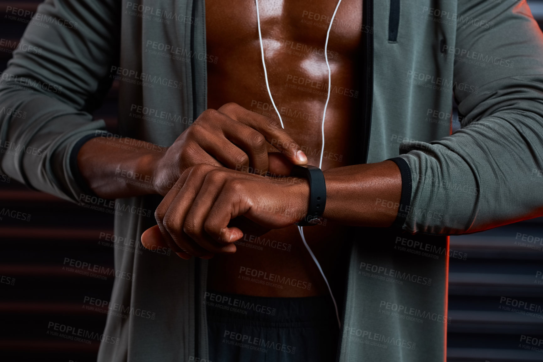 Buy stock photo Studio shot of an unrecognizable male athlete looking at his wrist watch against a grey background